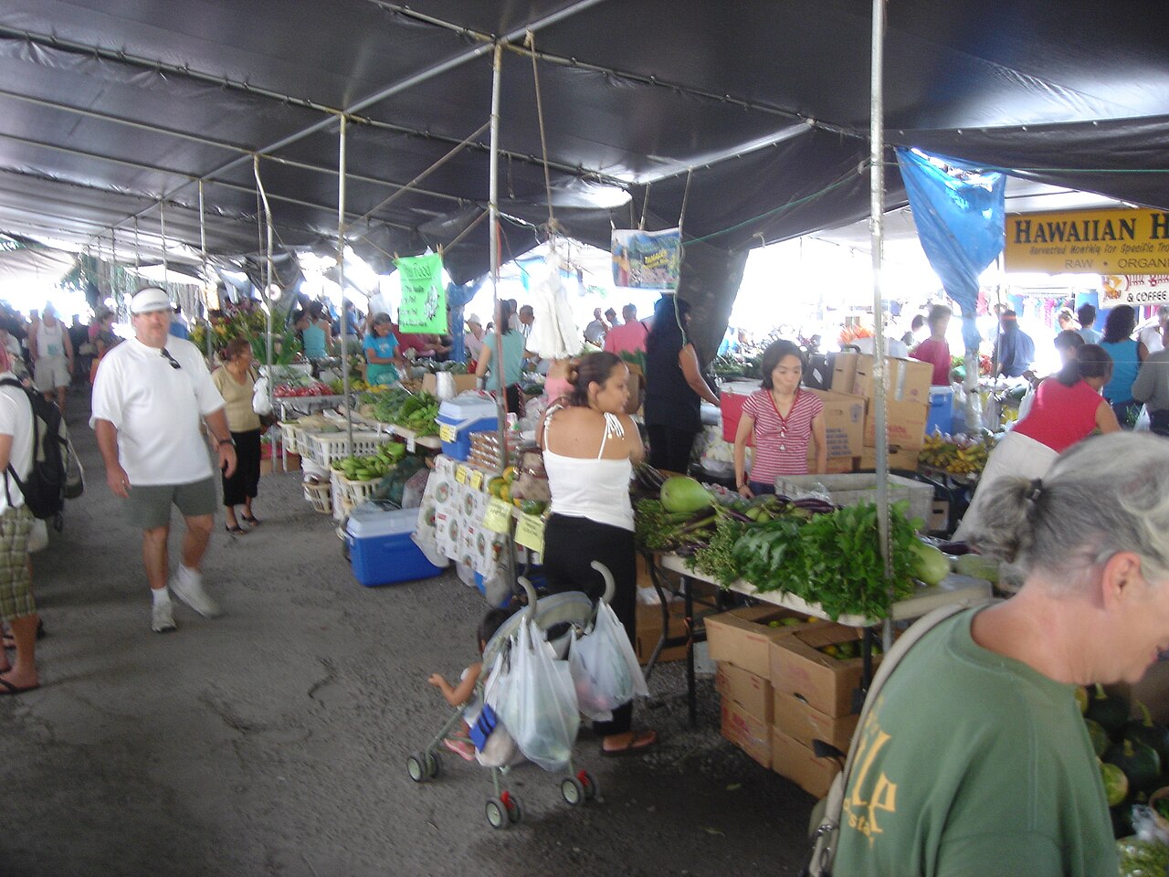 People shopping and working at the Hilo Farmers Market