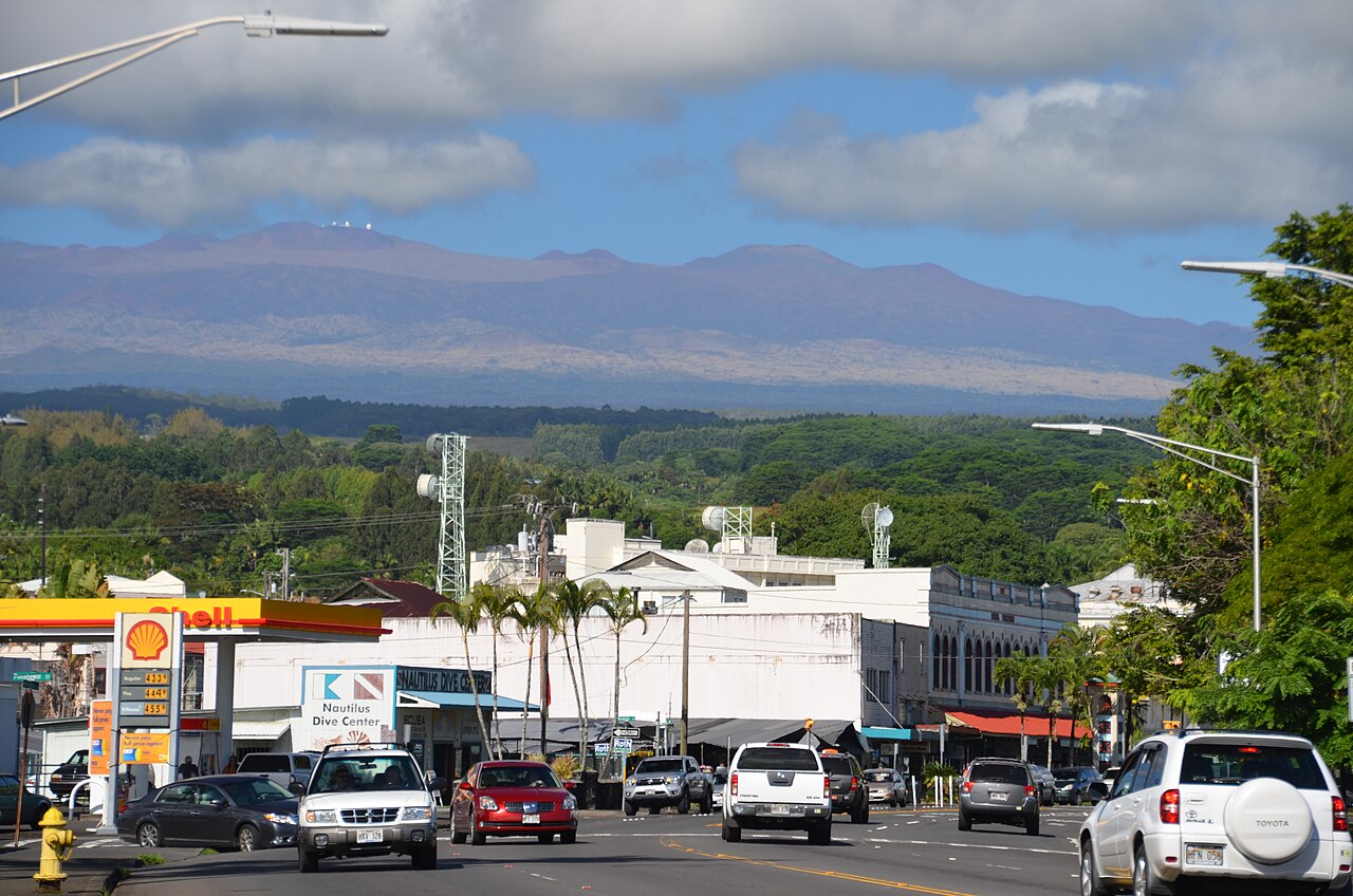 Downtown Hilo street with local buildings and Mauna Kea in the distance